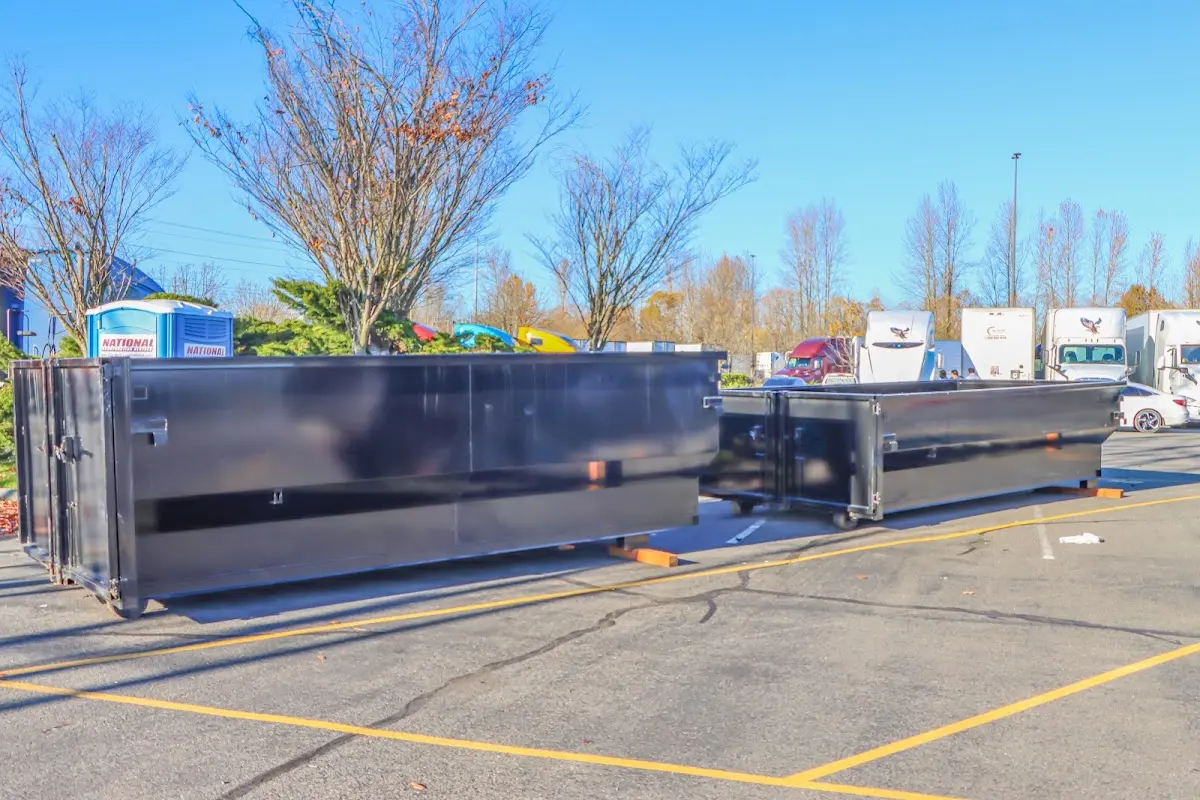 Professional dumpster rental service with roll-off container on residential driveway in McCook